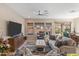 Spacious living room featuring contemporary decor, a ceiling fan, and views of the outdoor patio at 644 E Las Puertas Ln, Queen Creek, AZ 85140