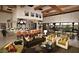 Elegant living room featuring exposed beams, comfortable seating, and an open-concept kitchen with bar seating at 644 E Las Puertas Ln, Queen Creek, AZ 85140