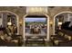Elegant lobby with stone accents, comfortable seating, and a view of a beautifully landscaped outdoor area at 644 E Las Puertas Ln, Queen Creek, AZ 85140