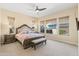 Main bedroom featuring neutral tones, an upholstered headboard, a bench, and multiple windows at 644 E Las Puertas Ln, Queen Creek, AZ 85140