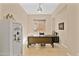 Well-lit office space featuring tile floors, a large desk, and a white safe at 644 E Las Puertas Ln, Queen Creek, AZ 85140