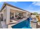 Stunning pool area with covered patio, outdoor dining, and relaxing water features for serene ambiance at 644 E Las Puertas Ln, Queen Creek, AZ 85140