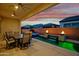 Backyard oasis featuring a sparkling pool with raised spa and elegant fire features at 644 E Las Puertas Ln, Queen Creek, AZ 85140