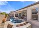 Inviting backyard oasis with a sparkling pool, hot tub, and covered patio perfect for outdoor entertaining at 644 E Las Puertas Ln, Queen Creek, AZ 85140