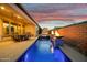 Beautiful pool with a cascading waterfall, a built-in spa, and a covered patio, perfect for relaxing evenings at 644 E Las Puertas Ln, Queen Creek, AZ 85140
