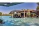 A community pool with stone bar and covered seating area and golf course views at 644 E Las Puertas Ln, Queen Creek, AZ 85140