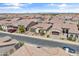 A street view of homes with desert landscaping and tile roofs nestled in a beautiful and modern community at 644 E Las Puertas Ln, Queen Creek, AZ 85140