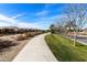 Scenic walking path lined with trees and landscaping in the community at 644 E Las Puertas Ln, Queen Creek, AZ 85140