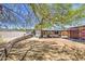 Spacious backyard with covered patio perfect for outdoor entertaining and relaxation underneath a large mature shade tree at 6728 N 24Th Dr, Phoenix, AZ 85015