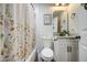 Bright bathroom showcasing floral shower curtain, vanity, and coordinating mirror at 6728 N 24Th Dr, Phoenix, AZ 85015