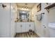 Bright bathroom features granite countertops, white cabinets, and wood look tile at 6728 N 24Th Dr, Phoenix, AZ 85015