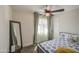 Well-lit bedroom featuring a ceiling fan, grey bed frame and neutral wall color at 6728 N 24Th Dr, Phoenix, AZ 85015
