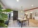 Elegant dining area with stylish table setting and a sliding barn door to the living area at 6728 N 24Th Dr, Phoenix, AZ 85015