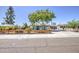 Attractive single-story house with a well-kept lawn, accented by a beautiful wooden fence and landscaping at 6728 N 24Th Dr, Phoenix, AZ 85015