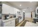 Spacious kitchen with granite counters, stainless appliances, and white cabinets at 6728 N 24Th Dr, Phoenix, AZ 85015