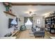 Inviting living room featuring a cozy sofa, stylish decor, and a mounted TV for entertainment at 6728 N 24Th Dr, Phoenix, AZ 85015