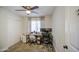 Home office has neutral carpet, ceiling fan, and desk set up in front of window at 6728 N 24Th Dr, Phoenix, AZ 85015