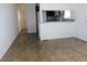 Modern kitchen area with breakfast bar, stainless steel sink, and tiled flooring at 7807 E Main St # H7, Mesa, AZ 85207