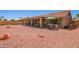 Large backyard with a covered patio, desert landscaping, and ample space for outdoor activities at 9234 W Sierra Pinta Dr, Peoria, AZ 85382