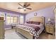 Bedroom featuring a ceiling fan, a bay window with a bench and ensuite bathroom at 9234 W Sierra Pinta Dr, Peoria, AZ 85382