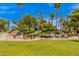 Beautifully landscaped community featuring a waterfall, mature trees, and manicured grounds with walking paths at 9234 W Sierra Pinta Dr, Peoria, AZ 85382