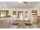 Sunlit dining area with a ceiling fan, tile floors, and large windows at 9234 W Sierra Pinta Dr, Peoria, AZ 85382
