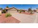 Well-maintained single-Gathering home with low-maintenance red rock landscaping and driveway at 9234 W Sierra Pinta Dr, Peoria, AZ 85382