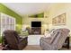 Cozy living room with vaulted ceilings, a fireplace, and plenty of natural light at 9234 W Sierra Pinta Dr, Peoria, AZ 85382