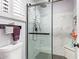 Updated shower with white marble tile, a rain shower head and a glass enclosure at 9234 W Sierra Pinta Dr, Peoria, AZ 85382