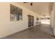 Spacious covered back patio with a secure gate and neutral color scheme at 9518 W Hazelwood St, Phoenix, AZ 85037