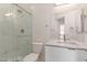 Bright bathroom featuring walk-in shower with glass door and modern vanity at 9518 W Hazelwood St, Phoenix, AZ 85037