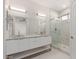 Modern bathroom features double sinks, a large mirror, and glass-enclosed shower at 9518 W Hazelwood St, Phoenix, AZ 85037