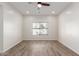 A naturally-lit bedroom boasts wood-look floors and a large window at 9518 W Hazelwood St, Phoenix, AZ 85037