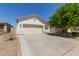 Home exterior view, featuring a concrete driveway, two car garage, and some desert landscaping at 9518 W Hazelwood St, Phoenix, AZ 85037