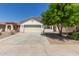 Charming single-story home featuring a well-maintained front yard and a two-car garage at 9518 W Hazelwood St, Phoenix, AZ 85037
