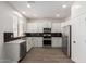 Beautiful, bright kitchen with modern white cabinets and stainless-steel appliances at 9518 W Hazelwood St, Phoenix, AZ 85037