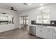Bright kitchen features stainless steel appliances, subway tile backsplash, and sliding doors at 9518 W Hazelwood St, Phoenix, AZ 85037