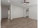 Bright living room with wood-look flooring and neutral paint is ready for your personal touch at 9518 W Hazelwood St, Phoenix, AZ 85037