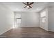 Spacious living room with modern ceiling fan and sleek, contemporary flooring throughout at 9518 W Hazelwood St, Phoenix, AZ 85037