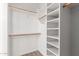 Bright walk-in closet features built-in shelves and wooden rods at 9518 W Hazelwood St, Phoenix, AZ 85037