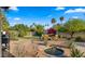 Relaxing backyard with seating, a water feature, mature landscaping, and a barbecue area, perfect for entertaining at 10025 E Larkspur Dr, Scottsdale, AZ 85260