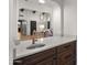 Stylish wet bar featuring marble countertops, dark wood cabinetry, and easy access to living area at 10025 E Larkspur Dr, Scottsdale, AZ 85260