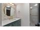 Chic bathroom with a modern vanity, gold hardware, decorative mirror, and a tiled shower at 10025 E Larkspur Dr, Scottsdale, AZ 85260