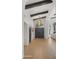 Grand foyer boasting high ceilings, wood beams, beautiful floors, and an elegant entry door at 10025 E Larkspur Dr, Scottsdale, AZ 85260