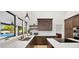 Well-appointed kitchen with white countertops, dark wood cabinetry, and a view of the outdoor pool at 10025 E Larkspur Dr, Scottsdale, AZ 85260