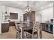 Open concept kitchen with dining area features updated cabinets, countertops, appliances, and modern lighting at 10025 E Larkspur Dr, Scottsdale, AZ 85260