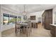 Spacious kitchen and dining area with natural light, updated fixtures, and views of the backyard oasis at 10025 E Larkspur Dr, Scottsdale, AZ 85260