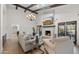 Open living area boasts a fireplace, large chandelier, and comfortable seating for relaxing at 10025 E Larkspur Dr, Scottsdale, AZ 85260