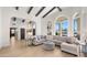 Bright and airy living room with high ceilings, wooden beams, and large windows showcasing outdoor views at 10025 E Larkspur Dr, Scottsdale, AZ 85260
