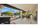 Outdoor patio with an outdoor kitchen, seating areas, and views of the pool and landscaped backyard at 10025 E Larkspur Dr, Scottsdale, AZ 85260